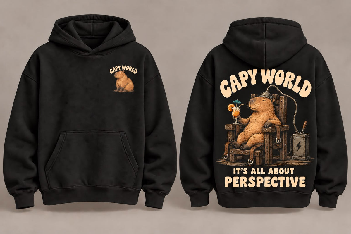 Capy World crni duks sa kapuljačom, mali motiv kapibare napred i veliki motiv sa natpisom It's all about perspective na leđima
